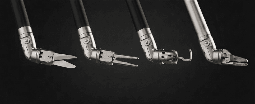 Yukalyptus LumaGrip end-effector family — monopolar scissors, precision dissector, monopolar hook, and micro-textured needle holder, each mounted on the 7-DoF articulated wrist.